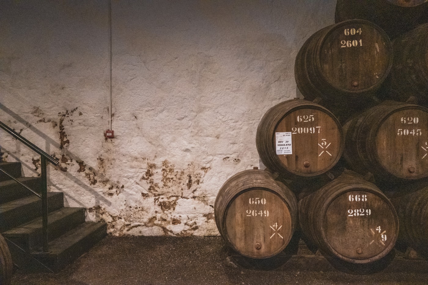 Stacked oak wine barrels in a winery cellar