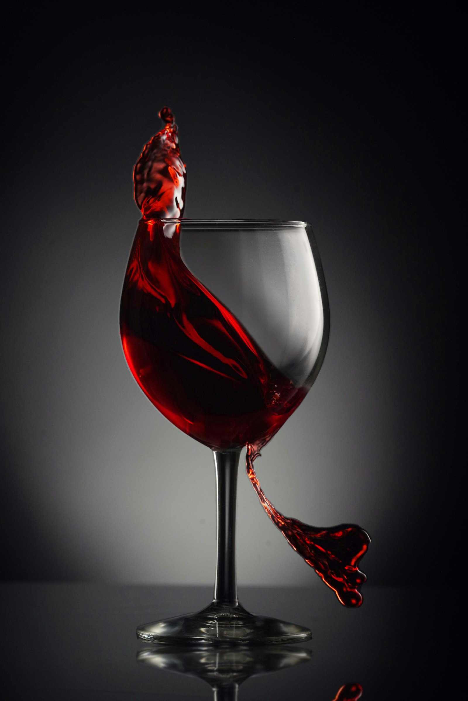 A glass of red wine on a wooden table
