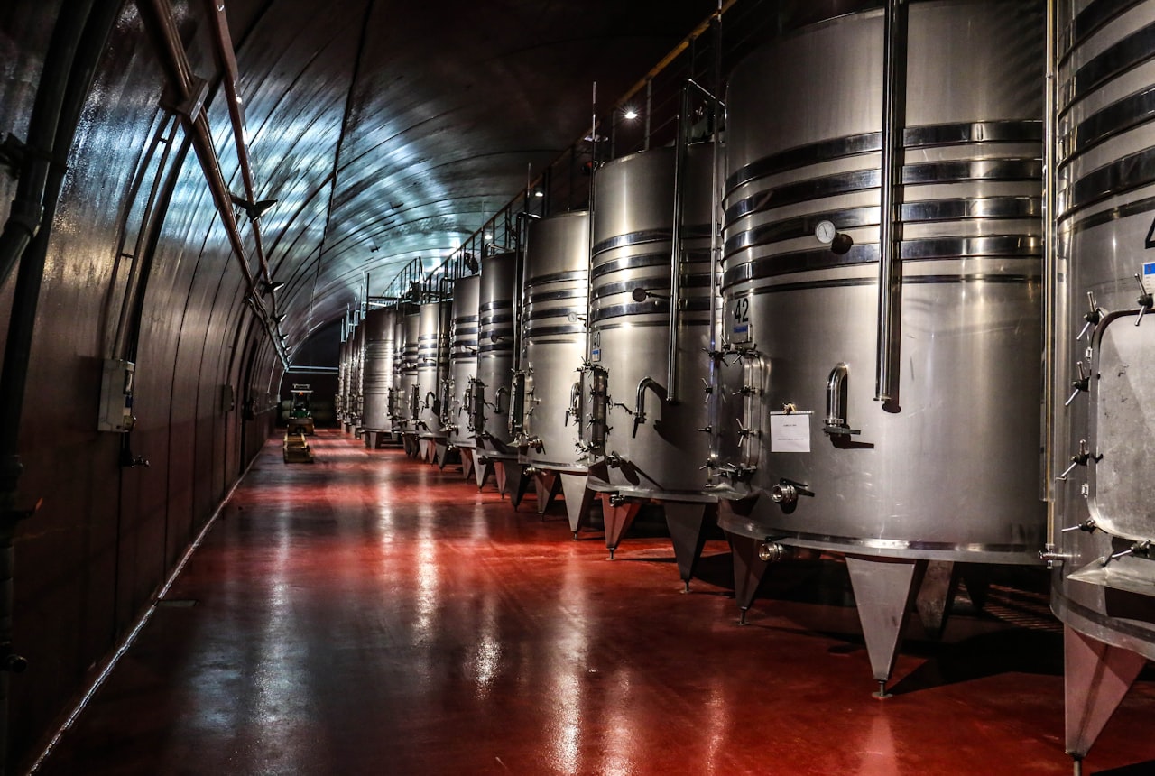 Large concrete egg fermenters in a modern winery in warm light