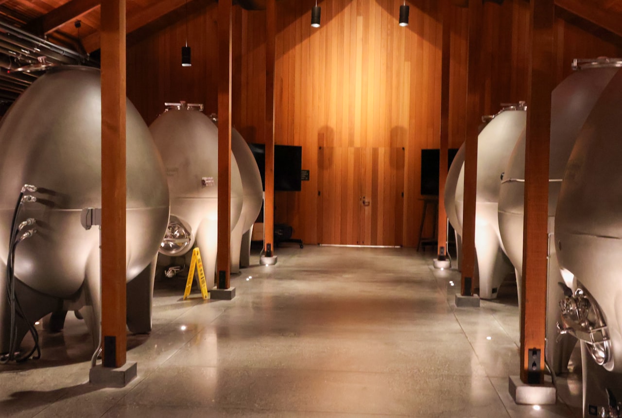 A modern Argentine winery cellar with concrete and steel tanks