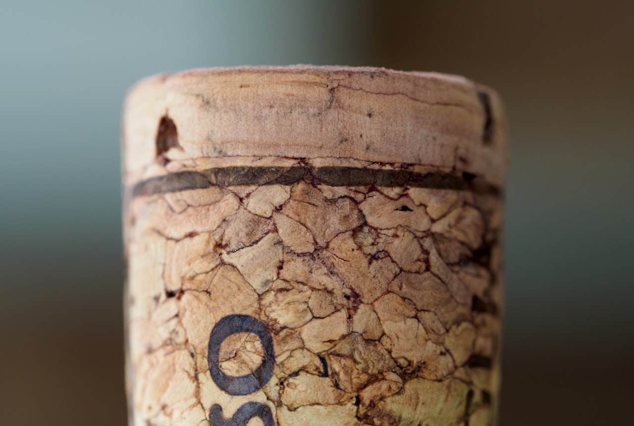 Extreme close-up of a wine cork in a bottle neck, showing the slight gap at the top