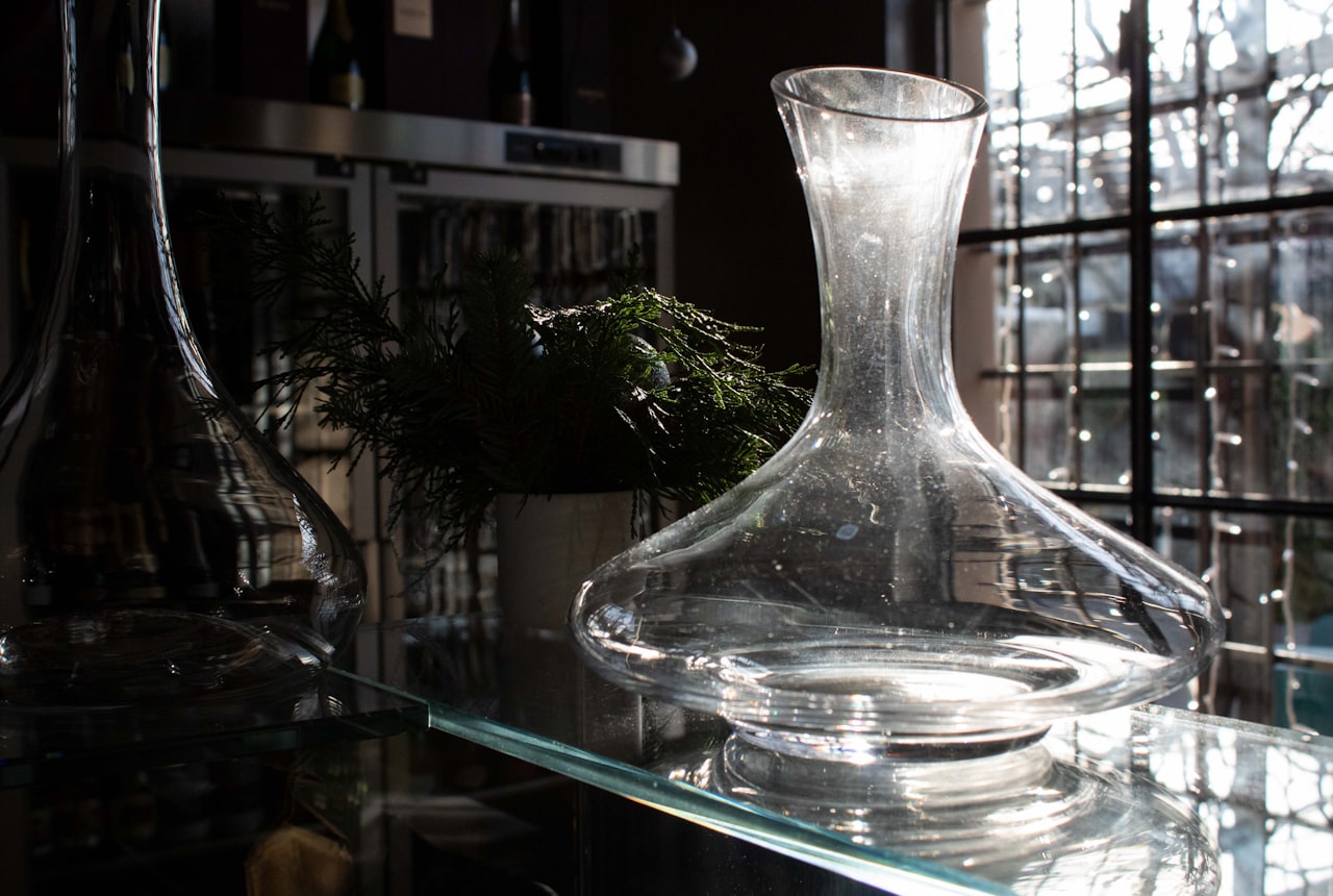 Two decanters side by side — a wide-base aeration decanter and a tall narrow sediment decanter