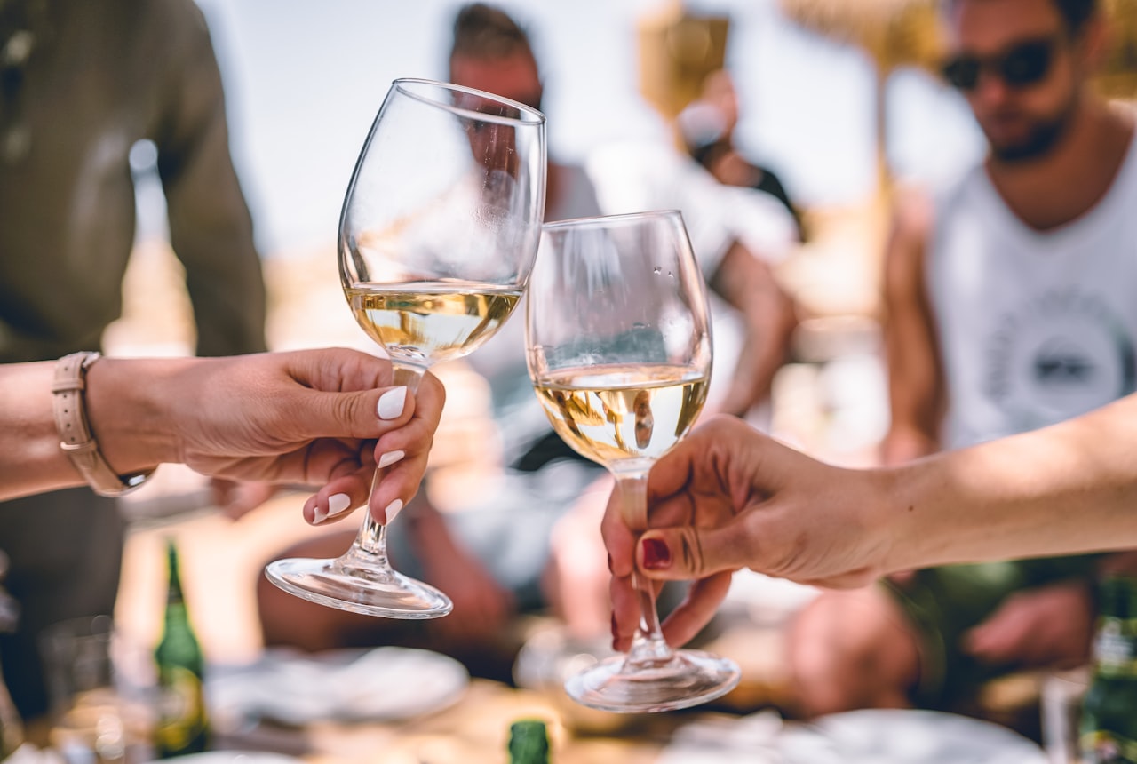 A glass of sparkling wine with bubbles rising in the glass, beautiful golden light