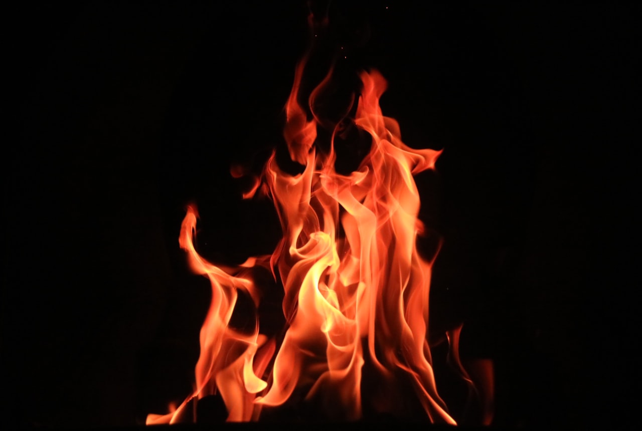 Flames rising against a dark background — the open fire used to toast barrel staves