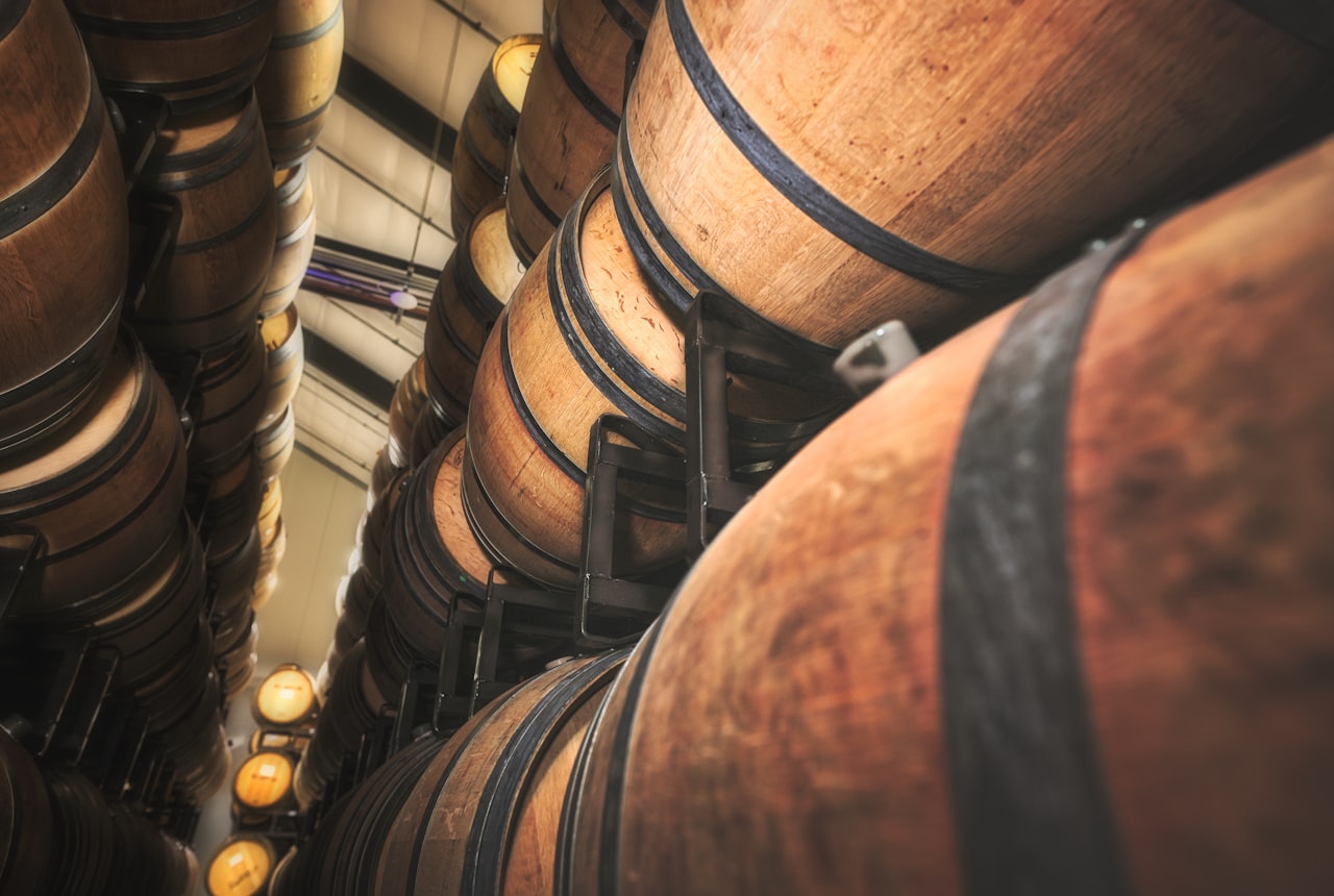 A row of three wine bottles with labels visible — premium Argentine, French, Italian — clean editorial shot